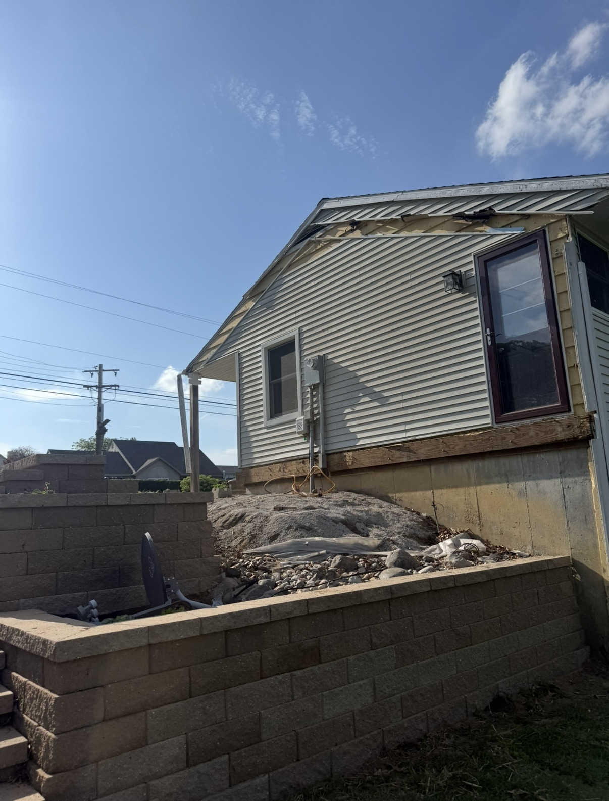 Rear of a house after the porch structure and decking were removed